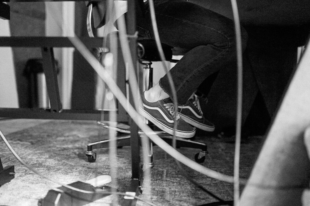 Broadcast engineer working with video cables and patch panel